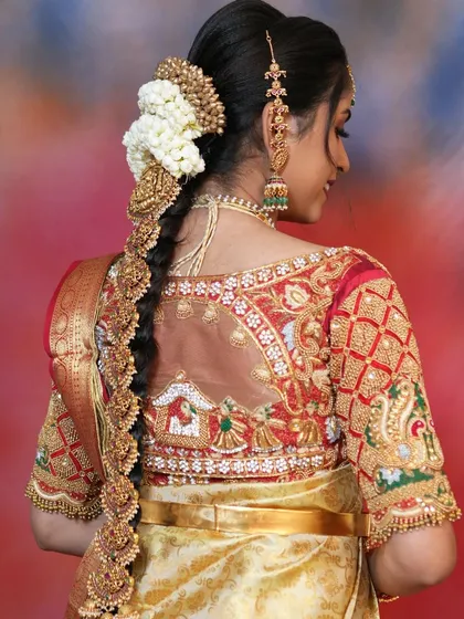 A bridal look is incomplete without the right hair accessory. This photo showcases a traditional bridal jade bille, or hair braid accessory, with beautiful temple designs that I styled to complete a classic South Indian wedding look.