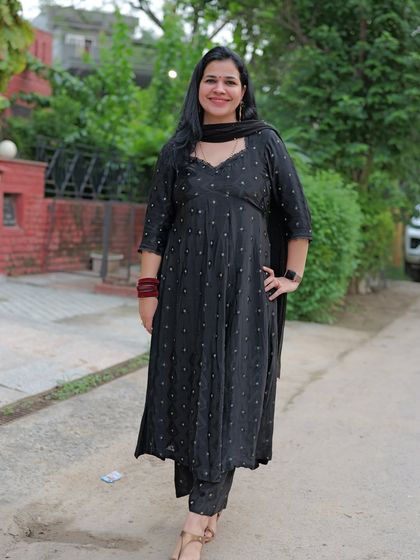 A closer look at a custom-stitched black suit with a beautiful sweetheart neckline, created from fabric. This design is simple, elegant, and very versatile.