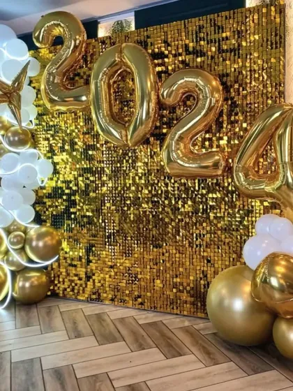 Ringing in the New Year calls for something spectacular. This 2024 party backdrop combines a dazzling gold sequin wall with large foil number balloons and a cascade of metallic gold and white balloons for a truly celebratory look.