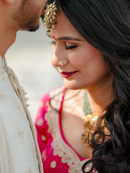 A serene close-up portrait of the bride, her eyes closed, capturing a moment of peace and happiness.