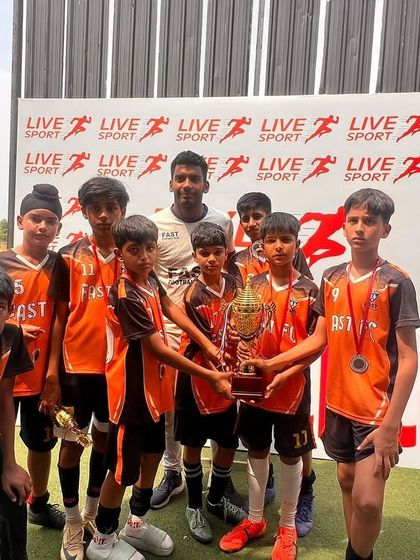 Our U11 team with their coach and the runners-up trophy from the Junior League.