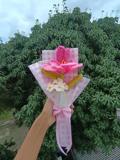 A custom pink bouquet with a large lily and forget-me-nots.