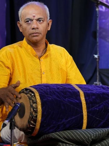 Vidwan Gurumurthy provides expert mridangam accompaniment, a crucial element of any Carnatic concert.