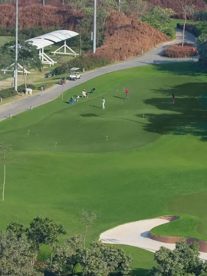 An aerial view of our pristine practice facilities, where our students hone their skills on the driving range and putting greens.
