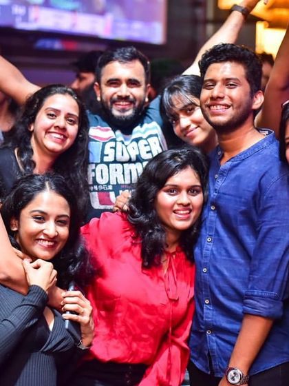 The energy of the crowd is everything. This group of friends is fully immersed in the music and the moment.