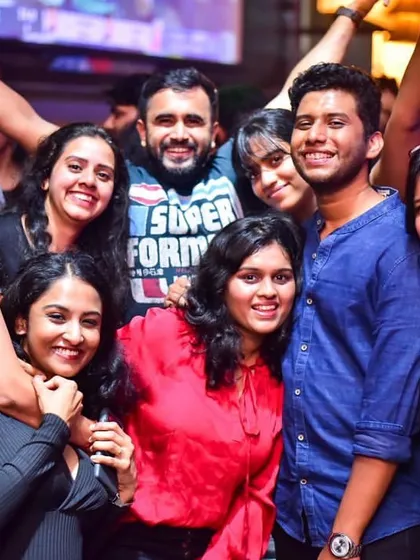The energy of the crowd is everything. This group of friends is fully immersed in the music and the moment.