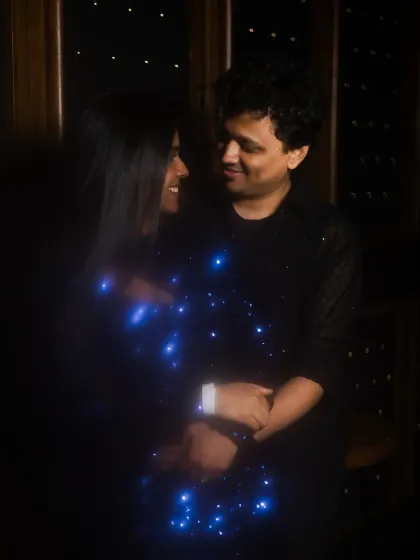 A romantic photo of the couple, with the bride's sparkling dress creating a beautiful, magical effect in the low light.