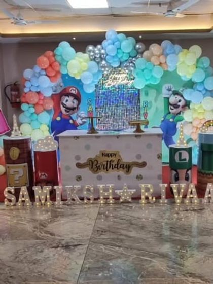 It's-a-me, Mario! A Super Mario themed birthday party with all the favorite characters like Mario, Luigi, and Princess Peach. The setup includes game-inspired props and a colorful balloon backdrop.