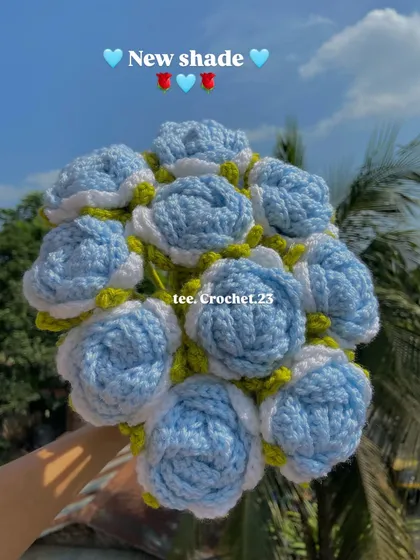 A beautiful new shade of light blue roses, held up against the sky to show their lovely color.