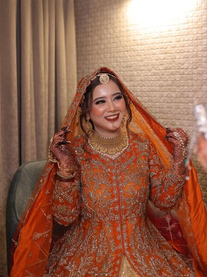 A candid shot of the bride smiling. Her happiness is infectious, and her glowing makeup enhances her natural radiance.
