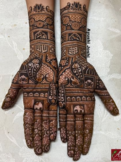 The full view of this engagement mehendi, combining paisley, peacocks, elephants, and floral elements for a rich, traditional design.