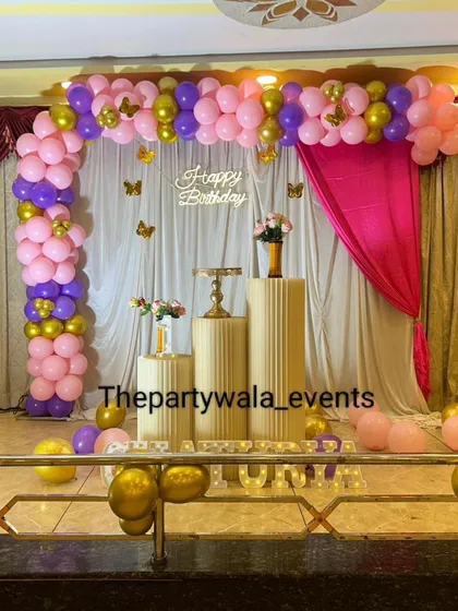 A simple yet beautiful butterfly theme with a pink, purple, and gold color scheme. The setup is perfect for a stage in a function hall.
