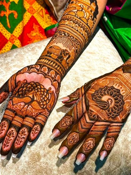 A beautiful design featuring peacocks on the palms and elephants on the arms.