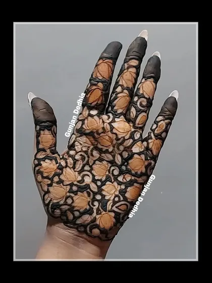 A full palm covered in a lotus cutwork design. This style is bold and modern, creating a beautiful stained-glass effect once the henna is removed.