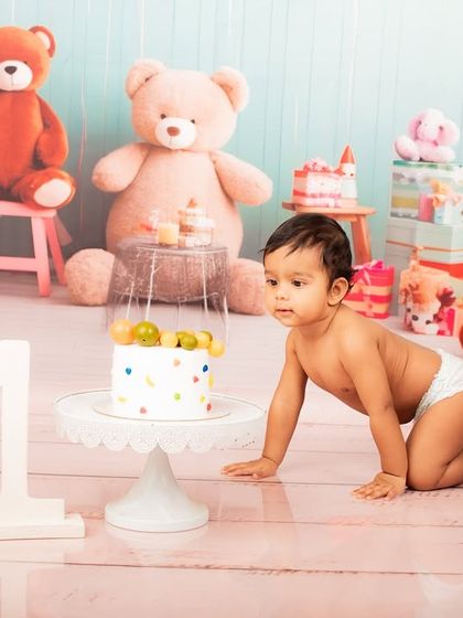 The crawl of anticipation. This little one is making his way towards the birthday cake, a perfect action shot from his first birthday photoshoot.
