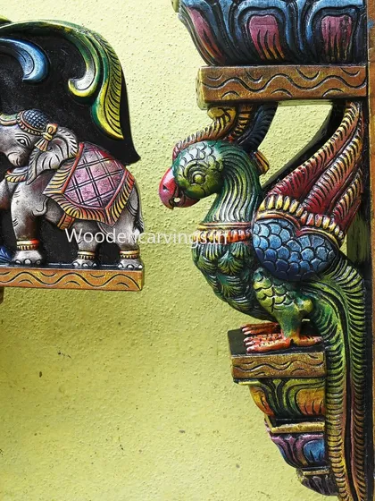 This image shows the parrot bracket and the elephant from the Gaja Ganesh panel side-by-side, highlighting the consistent quality of the painting and carving.