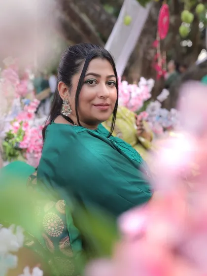 A beautiful portrait of the bride at her mehendi, framed by colorful flowers.