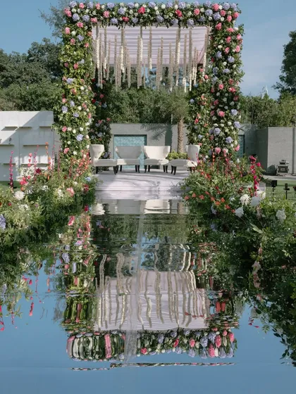 A mandap that feels like a dream. I used a full mirror aisle to reflect the lush pastel floral structure and the open sky, creating an ethereal and endlessly romantic setting for the wedding ceremony.
