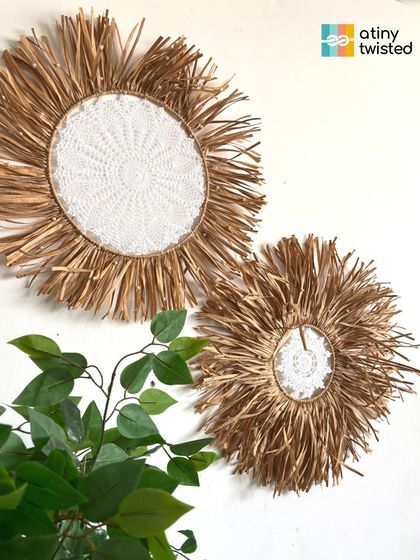 These sunburst-style wall hangings feature an intricate crochet doily at the center, surrounded by a burst of natural raffia. They bring so much warmth and texture to a space.