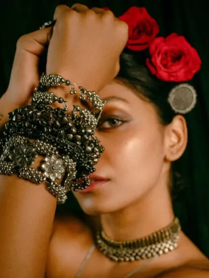 An artistic portrait from the 'INARA' series. The focus here was on the intricate details of the silver jewelry, using dramatic lighting and a close-up frame to create a moody, intimate portrait that highlights the craftsmanship of the accessories.