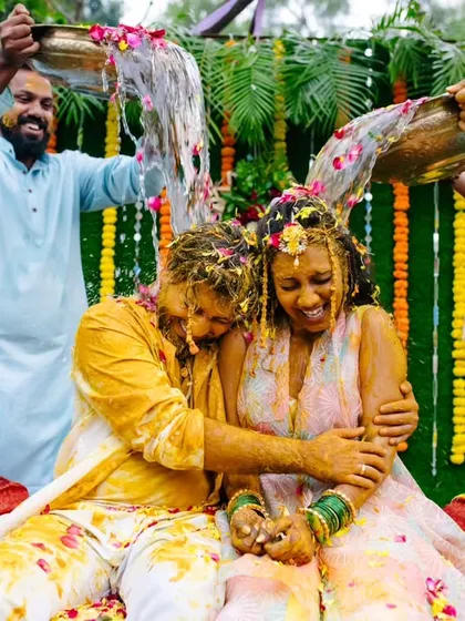 Another angle of the 'crazy haldi' fun, where the couple is drenched with water and turmeric in a moment of pure celebration.