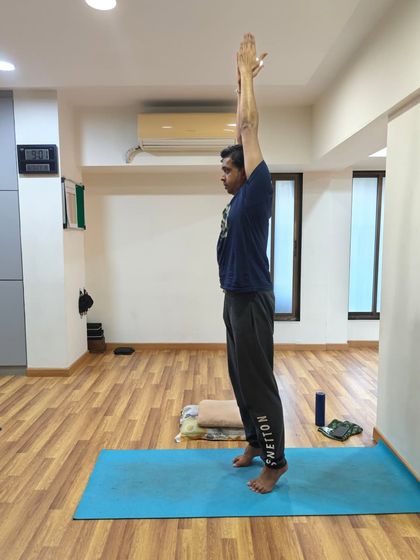 Finding stability in Tadasana. Notice the active engagement through the legs and the lengthening of the spine, creating a solid and grounded base.