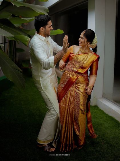 A playful and candid moment between the bride and groom, their laughter capturing the joy of their wedding day.