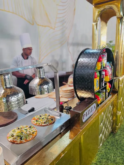 My chef at the pizza station, ensuring the pizzas are perfectly cooked and ready to be served.