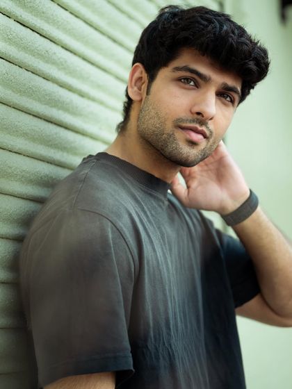 For a more urban and edgy feel, we shot this series against a textured shutter background. This close-up portrait focuses on the model's expression and uses soft, diffused light to highlight his features.