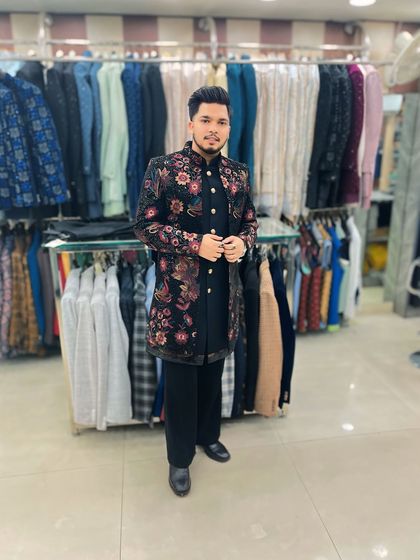 Another shot of the designer in the floral embroidered Indo-Western, seen against the backdrop of my extensive in-store collection.
