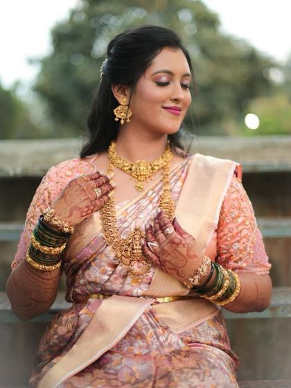 A beautiful bride in her traditional attire, her hands adorned with my henna work, showcasing the complete look.