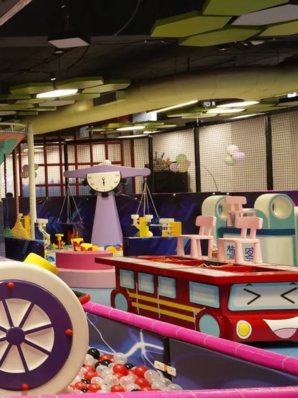 A glimpse of our colorful and whimsical toddler play area, featuring fun car-themed tables and other engaging structures.