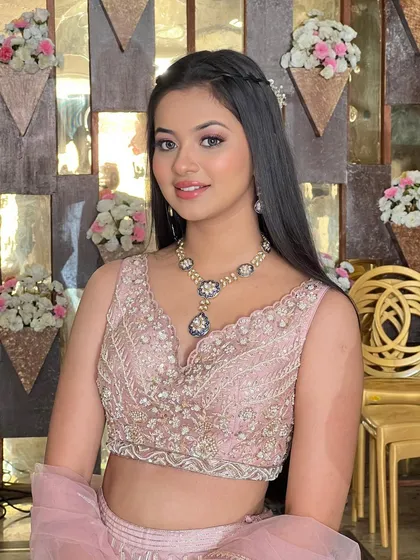 A gorgeous look in a pastel pink lehenga, with soft, shimmery makeup.