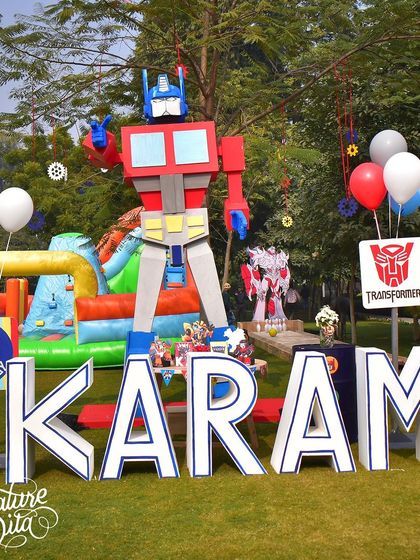 For this Transformers party, I created giant 3D letters spelling out the birthday boy's name, guarded by a towering Optimus Prime statue. This created a fantastic, personalised photo spot for the family.