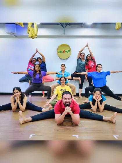 A fun group pose celebrating our community and the spirit of yoga. Together, we create shapes and support each other, embodying the unity that yoga teaches.