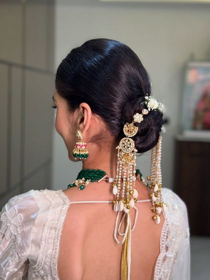 Another angle of the stunning bridal bun, showing the intricate placement of the hair jewelry and flowers for a look that is beautiful from every side.