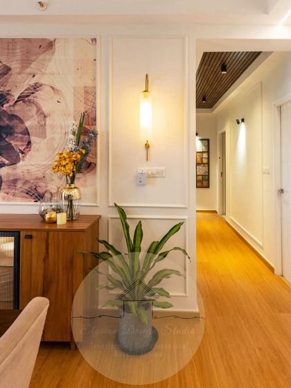 A beautiful dining area with a custom art wallpaper, a wooden sideboard with a built-in bar fridge, and elegant wall sconces. The design creates a perfect ambiance for hosting.