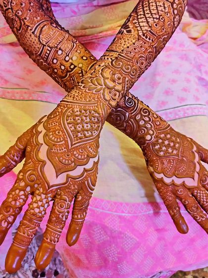 Saniya's beautiful bridal mehndi, showcasing the intricate patterns on her hands from different angles.