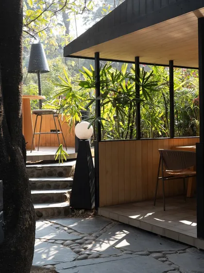A view of one of the open-air seating areas, where the architecture is minimal, allowing the focus to remain on the garden.