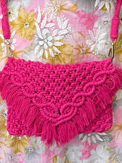 I just love this hot pink sling bag! The color is so vibrant and happy. It has a beautiful V-flap design with fringes and a sturdy braided strap, making it a perfect statement piece for any outfit.