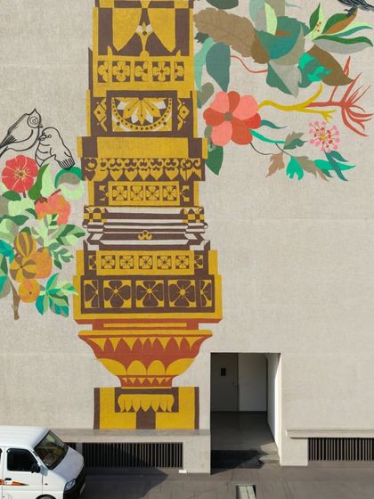 The base of the 'Tower of Harmony' mural, showing how the artwork grounds the contemporary building in local culture and symbolism. This piece stands as a testament to our ability to execute large-scale public art projects with deep narrative meaning.