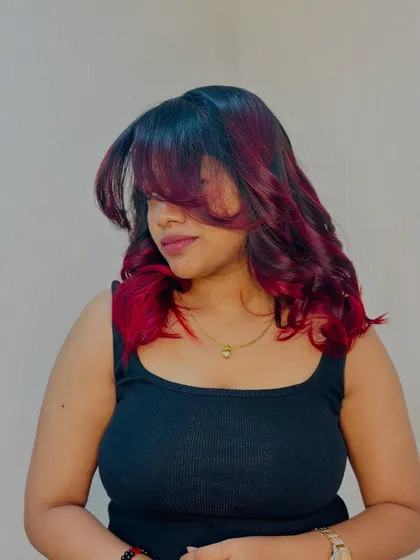 A stylish shot with face framing bangs, this look is all about attitude and bold color.