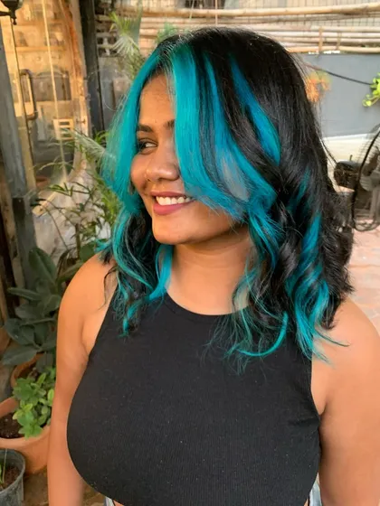 A side profile of the turquoise money piece, showing how it brightens up her whole look.