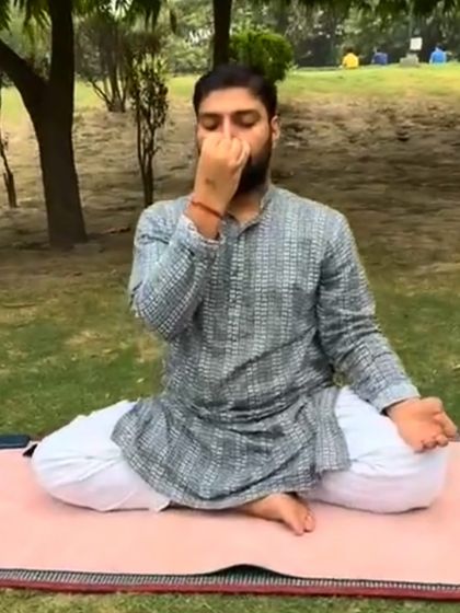 A student practicing Nadi Shodhan Pranayama outdoors, connecting the inner breath with the rhythm of nature.