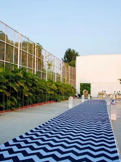 A long view of the custom chevron-patterned carpet we had made for this outdoor event. It created a grand walkway for guests.