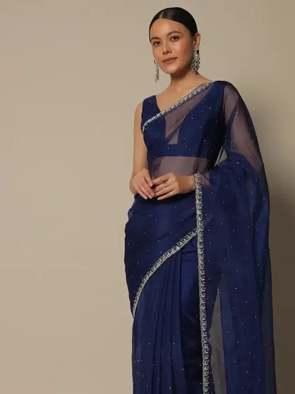 A classic look for the Kalki Fashion campaign. The sleek low ponytail and simple, elegant makeup ensure that the focus is on the beautiful navy blue organza saree.