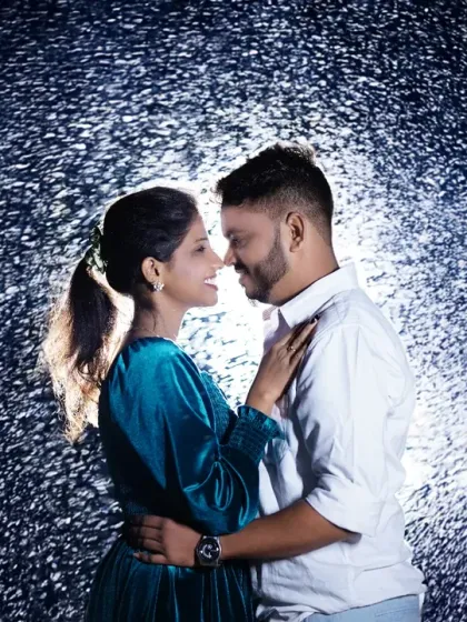A dramatic pre-wedding portrait using a rain effect for a cinematic feel. This backlit shot creates a beautiful silhouette and highlights the couple's connection.