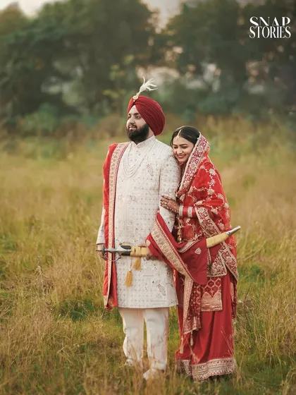 A candid moment of the couple outdoors, the bride leaning affectionately on her groom. We aim to capture the natural comfort and love between our couples.