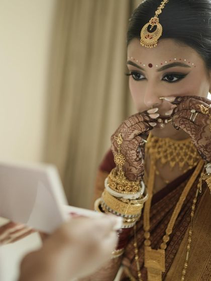 A candid moment of reflection. This shot captures the intricate details of her henna and the traditional bangles.