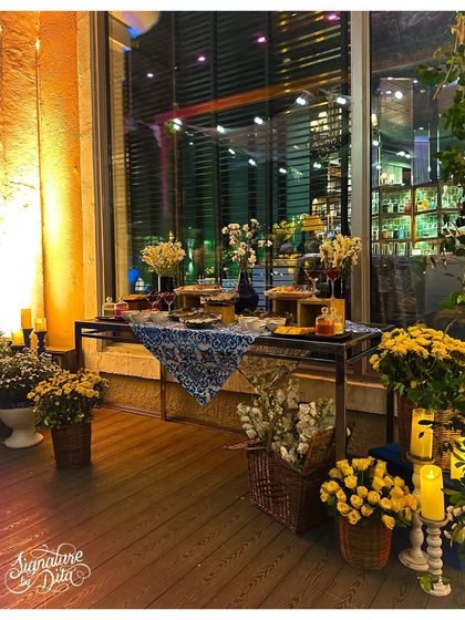 The appetizer and dessert table was styled with baskets of fresh flowers, glowing candles, and beautiful platters, all set against the warm glow of the city lights outside.